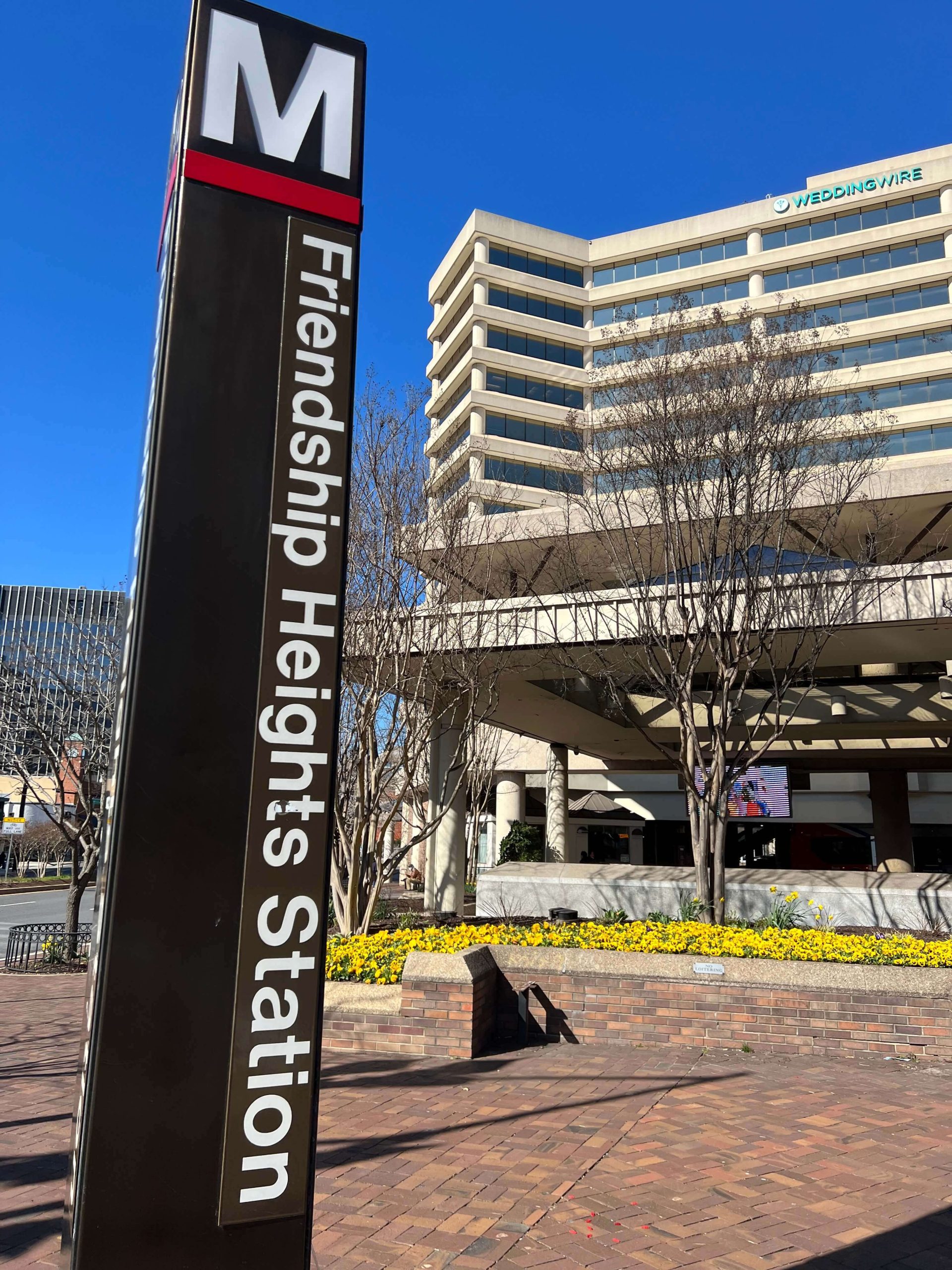 The Friendship Heights Metro Station sign, with Monarch Wellness office in the background.