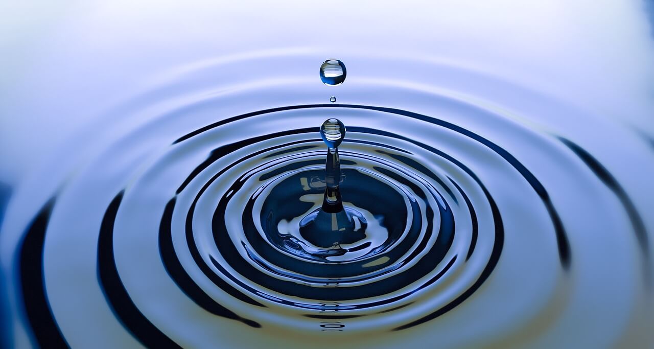 A drop with ripples depicting how addiction and trauma can have ongoing effects.
