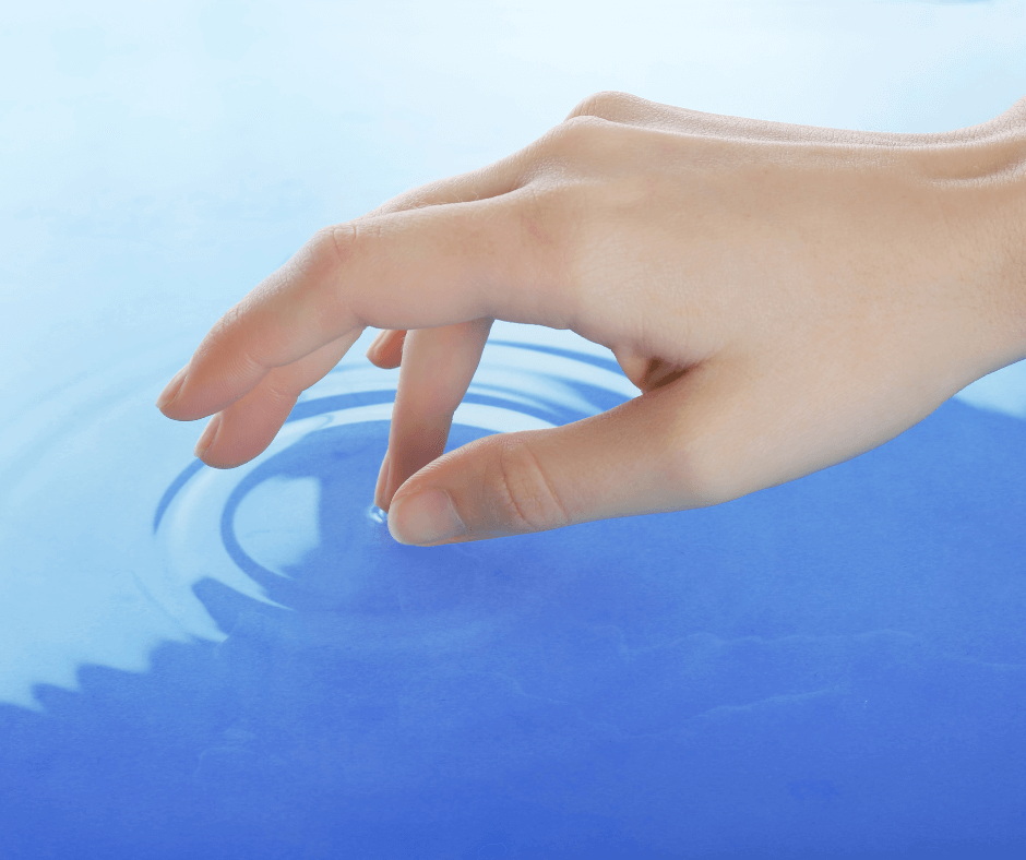 Hand making ripples in water to illustrate how psychotherapy is healing.